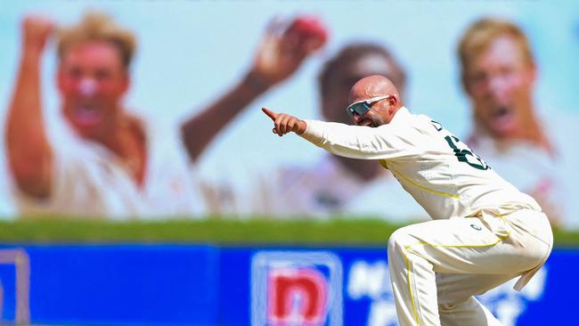 Nathan Lyon unsuccessfully appeals for a LBW with images of Shane Warne in the background at the Galle International Cricket Stadium. Picture: Ishara S. Kodikara/AFP