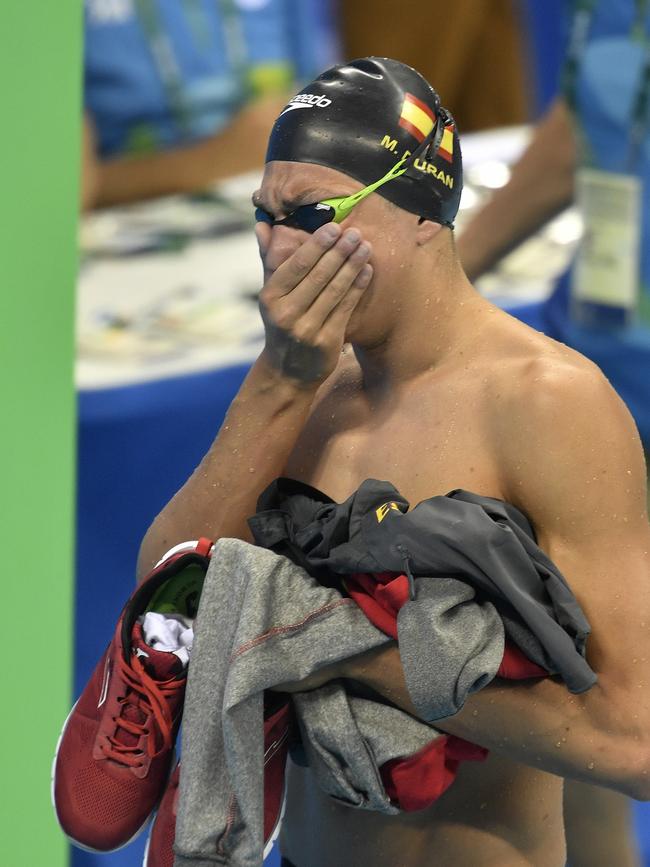 Spain’s Miguel Duran Navia cries after thinking he was disqualified for a false start but was later allowed back into the race