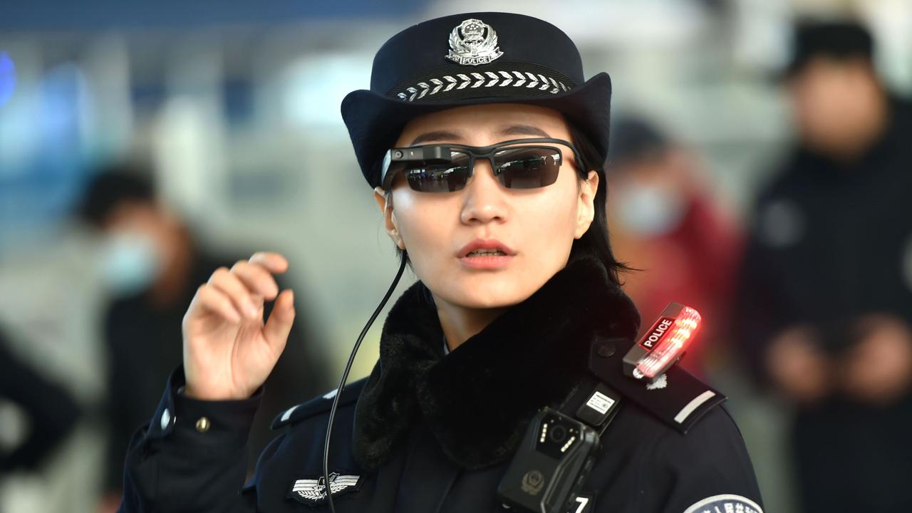 A police officer wearing a pair of smartglasses with a facial recognition technology equipped. Picture: AFP