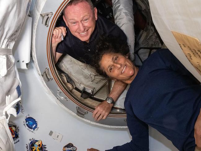 (FILES) This undated handout picture from Nasa released on July 2, 2024 shows NASAâs Boeing Crew Flight Test astronauts (from top) Butch Wilmore and Suni Williams inside the vestibule between the forward port on the International Space Stationâs Harmony module and Boeing's Starliner spacecraft. NASA needs to decide by the end of August whether to return two astronauts to Earth aboard Boeing's Starliner, which flew them to the International Space Station (ISS), or bring them home on a SpaceX craft, officials said on August 14, 2024. NASA astronauts Barry "Butch" Wilmore and Sunita "Suni" Williams blasted off for the ISS on Starliner on June 5 for what was meant to be an eight-day stay. (Photo by Handout / NASA / AFP) / RESTRICTED TO EDITORIAL USE - MANDATORY CREDIT "AFP PHOTO / NASA" - NO MARKETING NO ADVERTISING CAMPAIGNS - DISTRIBUTED AS A SERVICE TO CLIENTS