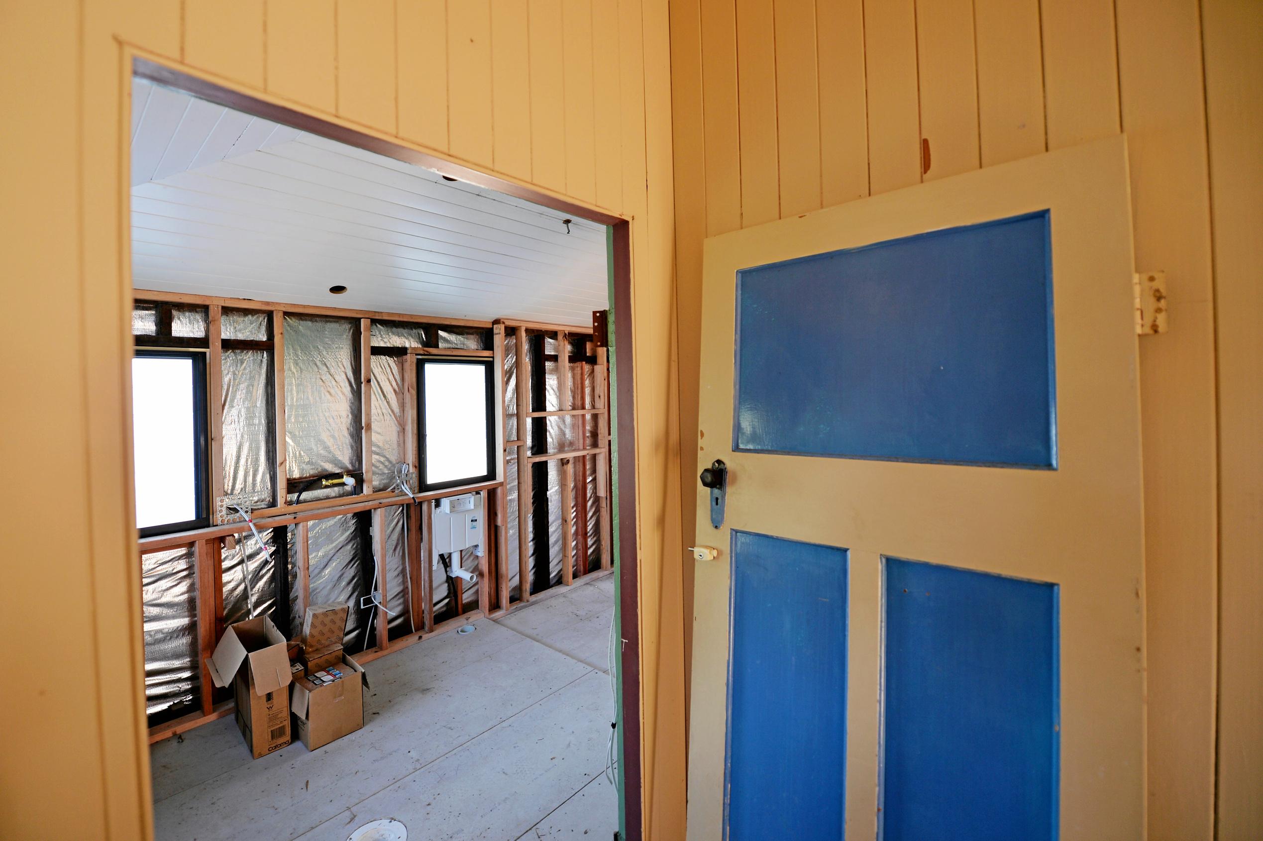 Mackay house-flippers Madison Strutynski and Michael Cotter at their Hunter St, West Mackay property. Picture: Stuart Quinn