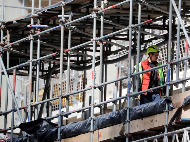 A worker in a hard hat works on a building construction site in central London on May 11, 2020, as life in Britain continues during the nationwide lockdown due to the novel coronavirus pandemic. - British Prime Minister Boris Johnson on May 10 announced a phased plan to ease a nationwide coronavirus lockdown, with schools and shops to begin opening from June 1 -- as long as infection rates stay low. Starting this week, he said the government would be "actively encouraging" people to return to work where they could not do so from home, for example in manufacturing or construction. (Photo by Tolga AKMEN / AFP)