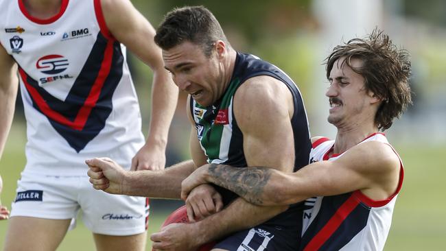 AFL Yarra Ranges’ Chris Graham is wrapped up by Anthony Vella of the South-East Football Netball League. Picture: Valeriu Campan