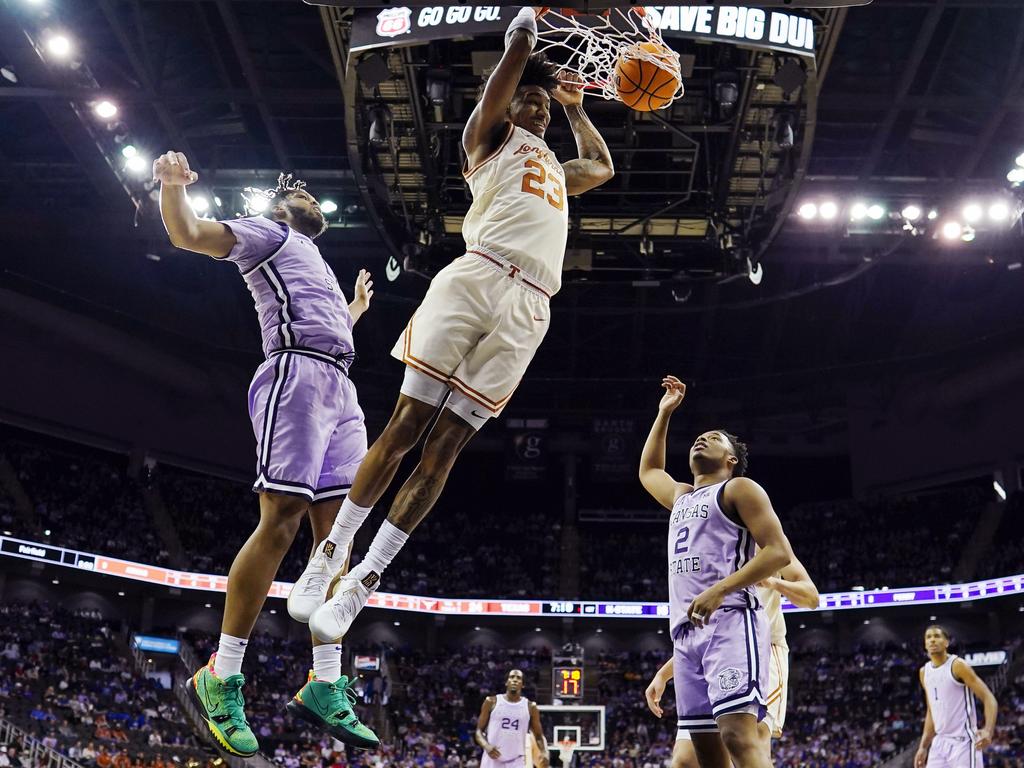 Dillon Mitchell of the Texas Longhorns dunks against Will McNair Jr. and Tylor Perry of the Kansas State Wildcats. Picture: Jay Biggerstaff/Getty Images