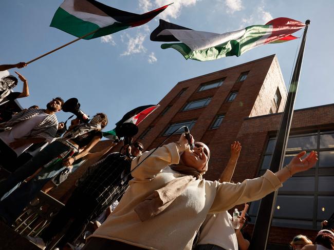 WASHINGTON, DC - MAY 02: Pro-Palestinian demonstrators use a large Palestinian flag to block the doors to Bell Hall as they rally on the campus of George Washington University on May 02, 2024 in Washington, DC. Pro-Palestinian encampments have sprung up at college campuses around the country with some protestors calling for schools to divest from Israeli interests amid the ongoing war in Gaza.   Chip Somodevilla/Getty Images/AFP (Photo by CHIP SOMODEVILLA / GETTY IMAGES NORTH AMERICA / Getty Images via AFP)