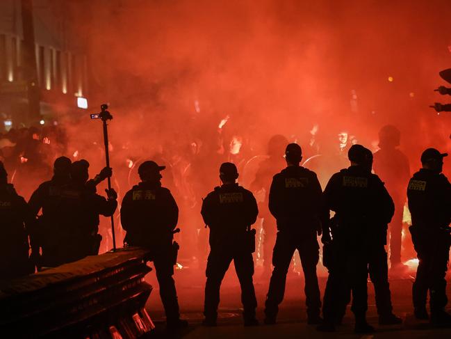 Police hold back Victory supporters lighting flares before the game. Picture: David Caird
