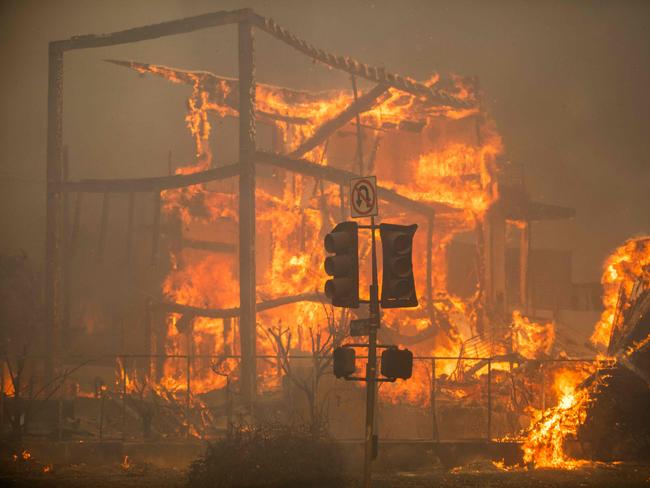 Flames from the Palisades fire burn a building on Sunset Boulevard. Picture: Getty Images