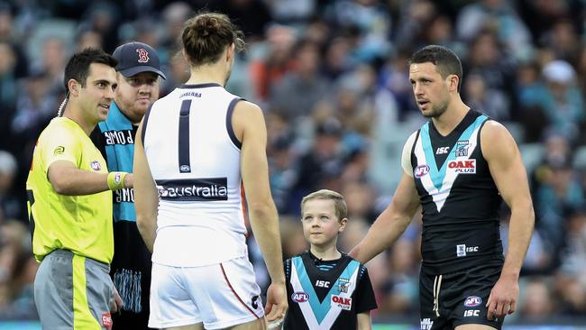 Last year’s Captain for the Day Henry Mickan tosses the coin with Travis Boak and GWS co-captain Phil Davis. Picture SARAH REED