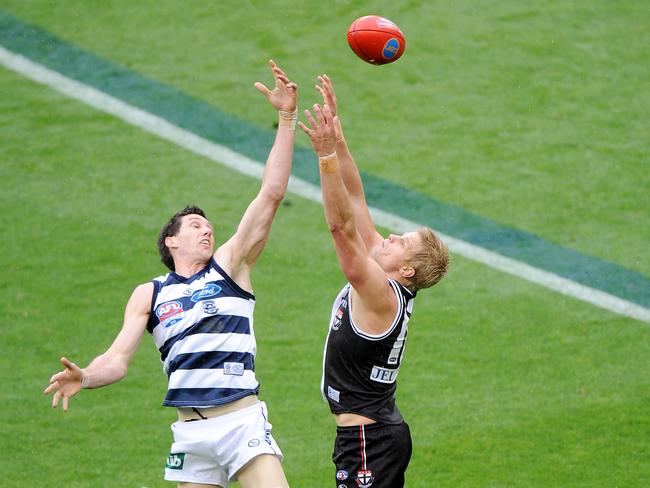 Harry Taylor gets a fist in against Nick Riewoldt.