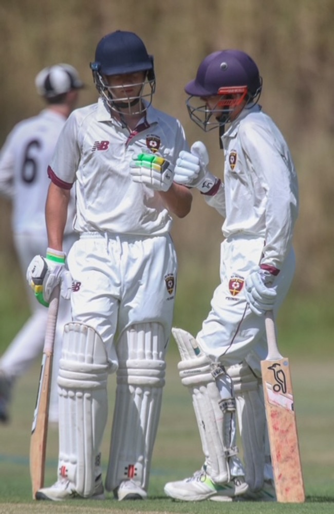 St Peters batsmen discuss tactics against the Iona attack.