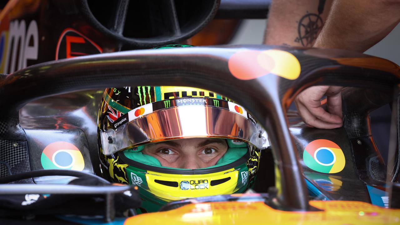 McLaren’s Oscar Piastri opens his eyes to adjust for the bright light as he is fitted into the car before heading out on the track. Picture: NewsWire/ David Caird