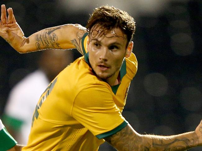 LONDON, ENGLAND - SEPTEMBER 08: Taiseer Aljassam of Saudi Arabia tries to tackle Chris Herd of Australia during the International Friendly match between Saudi Arabia v Australia at Craven Cottage on September 8, 2014 in London, England. (Photo by Ian Walton/Getty Images)