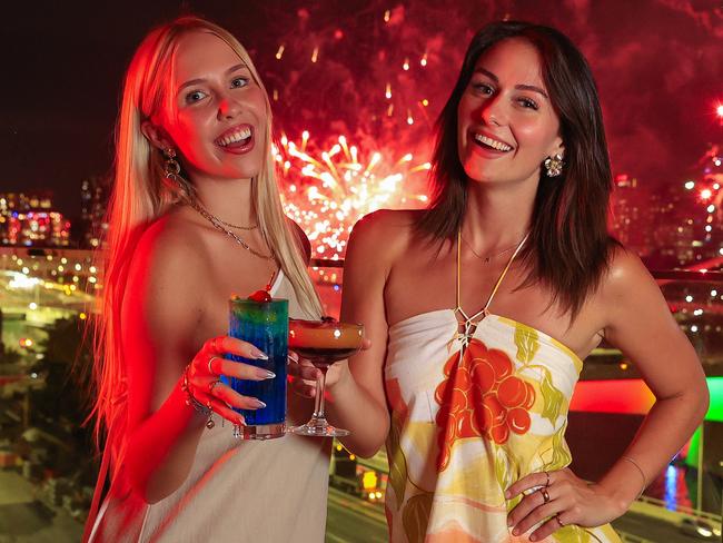 Lucy Evans and Ally West enjoy New Years Eve fireworks from the WET Deck at W Brisbane. Pics Adam Head