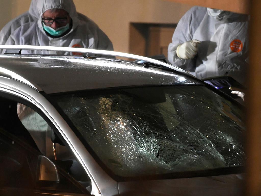 Police inspect the car involved in the incident. Picture: AFP