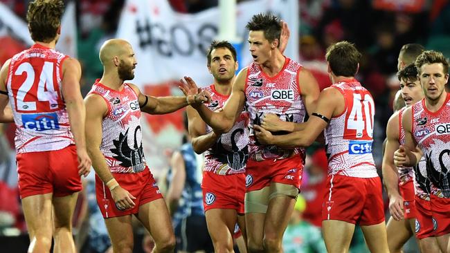 Callum Sinclair celebrates a goal with Dane Rampe, Jarrad McVeigh, Josh Kennedy, Nick Smith, George Hewett and Luke Parker against the Blues. Picture: AAP Images