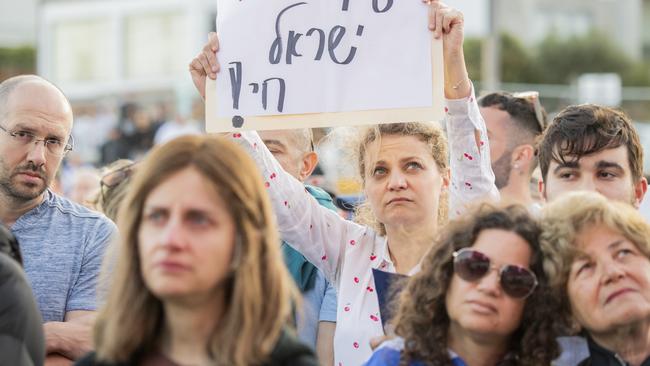 Some in the crowd held up signs. Picture: NCA NewsWIRE / Monique Harmer