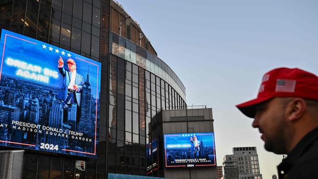 TOPSHOT - Supporters of former US President and Republican presidential candidate Donald Trump arrive for a campaign rally at Madison Square Garden in New York, October 27, 2024. (Photo by ANGELA WEISS / AFP)