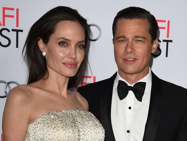 (FILES) In this file photo taken on November 05, 2015 Writer-director-producer-actress Angelina Jolie Pitt (L) and actor-producer Brad Pitt arrive for the opening night gala premiere of Universal Pictures' 'By the Sea' during AFI FEST 2015 presented by Audi at the TCL Chinese Theatre in Hollywood, California. - Brad Pitt allegedly hit one of his children in the face and choked another during a fight with Angelina Jolie on a private plane, according to court papers filed October 4, 2022 in the United States by his ex-wife. (Photo by MARK RALSTON / AFP)