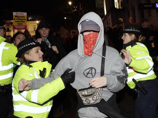 People scuffle with police during an anti-Boris Johnson demonstration, at Trafalgar Square in central London after Boris Johnson's gamble paid off as voters gave the UK prime minister a commanding majority to take the country out of the European Union. Picture: AP