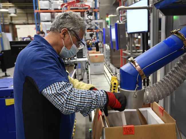 An employee is at work at the factory of US multinational pharmaceutical company Pfizer in Puurs during a visit of the European Commission President. Picture: AFP