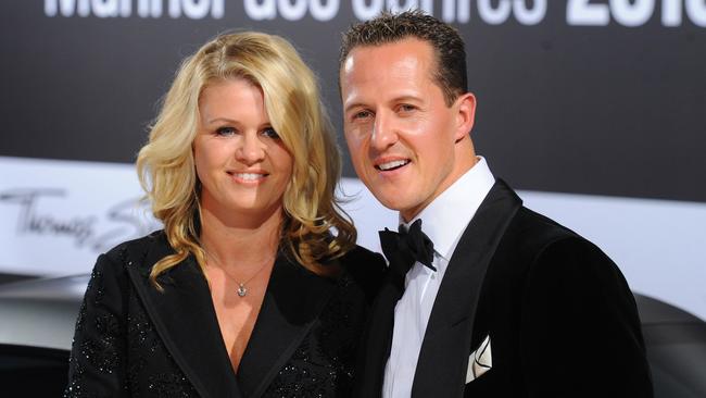 Formula-One driver Michael Schumacher and his wife Corinna arrive for the GQ gala 'Men of the Year' in Berlin on October 29, 2010.  AFP PHOTO / JENS KALAENE  GERMANY OUT / AFP PHOTO / DPA / JENS KALAENE