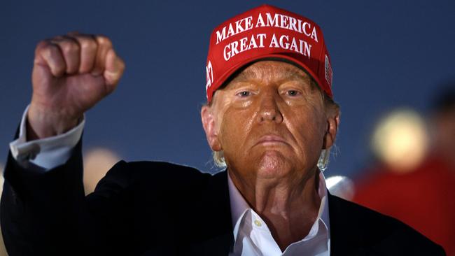 Donald Trump raises his fist during a NASCAR race in Concord, North Carolina. Picture: Getty Images.