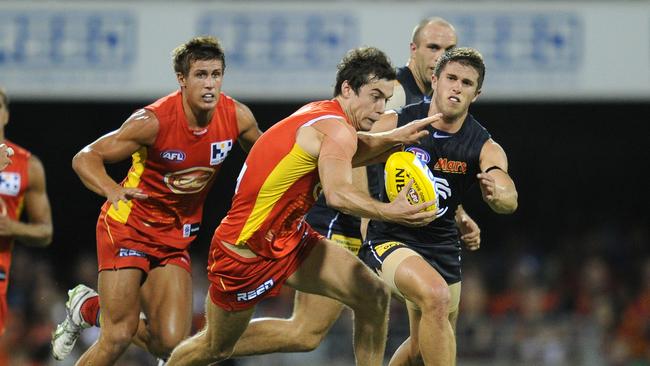 Suns player Marc Lock runs with the ball during the 2nd round AFL match between the Gold Coast Suns and Carlton at the Gabba in Brisbane, Saturday, April 2, 2011. (AAP Image/Dave Hunt) NO ARCHIVING