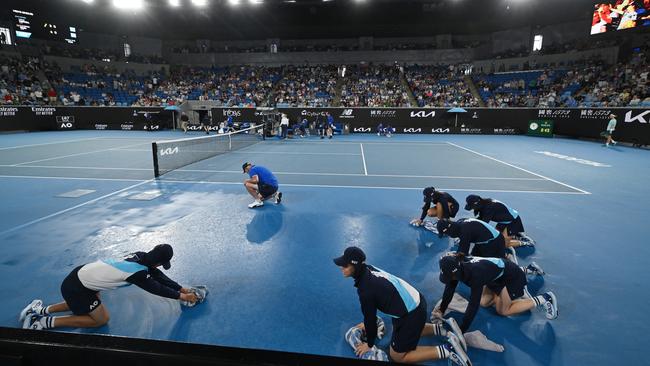 A frantic court-drying mission took place after a brief downpour at the end of the first set between Max Purcell and Casper Ruud. Picture: Morgan Hancock / Getty Images