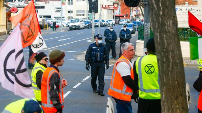 An Extinction Rebellion protesters in Launceston's CBD is spoken to by police on Thursday July 16, 2020. Picture: PATRICK GEE