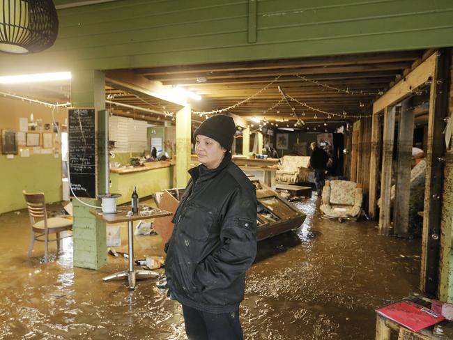 Julia Ridgers surveys the significant damage to the dining room at Brookfield Shed. Pictures: MATHEW FARRELL