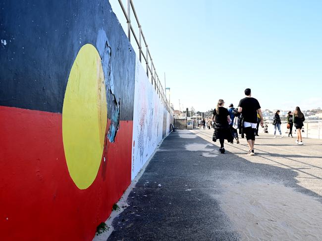 The Aboriginal flag is painted on the promenade at Bondi Beach