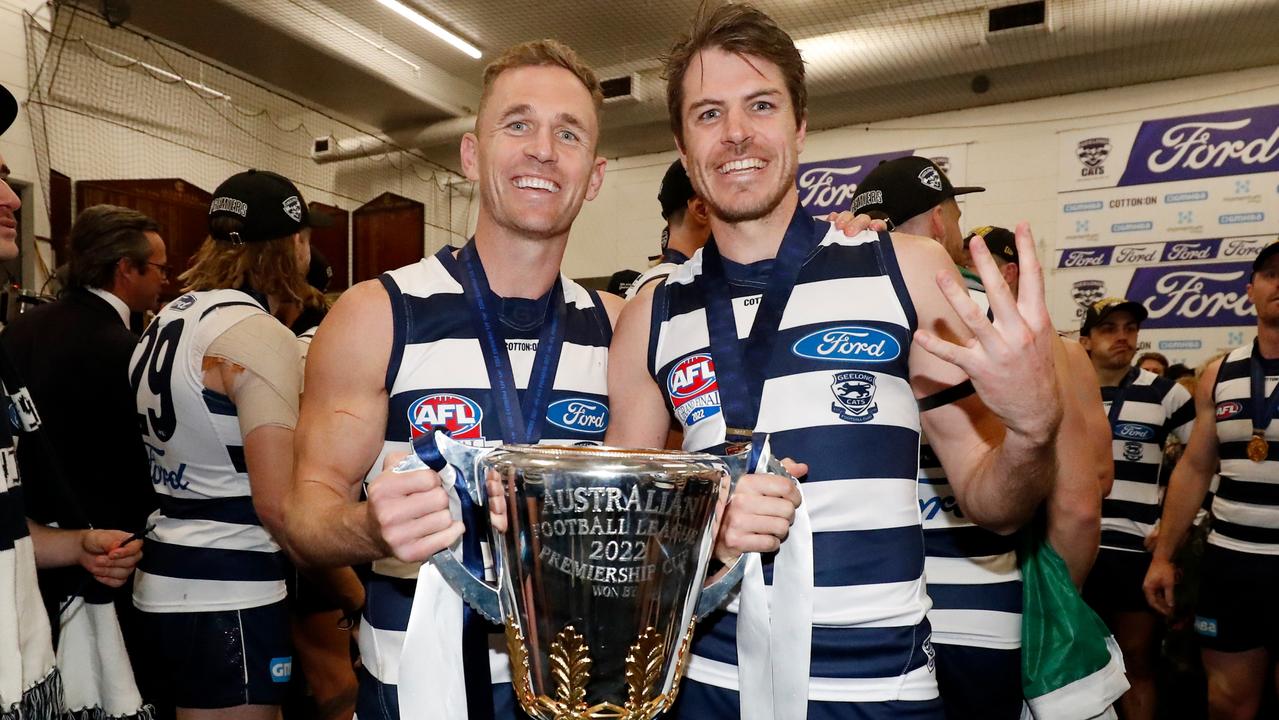 Joel Selwood and Isaac Smith pose for a photo with the premiership cup in the Geelong rooms. Picture: Dylan Burns/AFL Photos via Getty Images