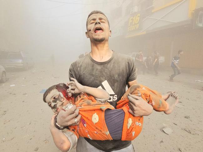 A man carries an injured Palestinian child as Israeli attacks continue on Jabalia refugee camp in Gaza City. Picture:Anadolu via Getty Images