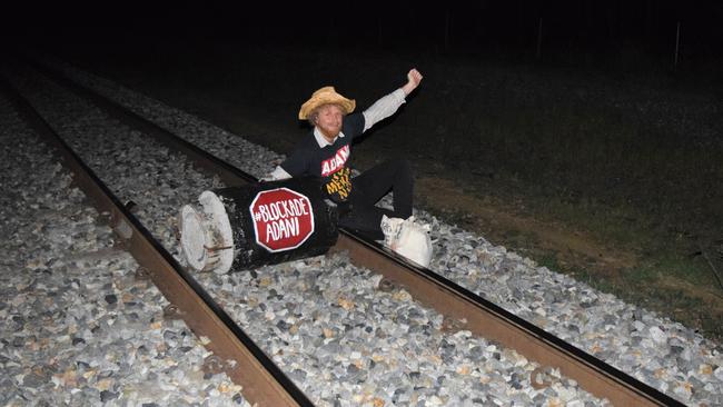 A protester blocked the Abbot Point Coal Terminal rail line.