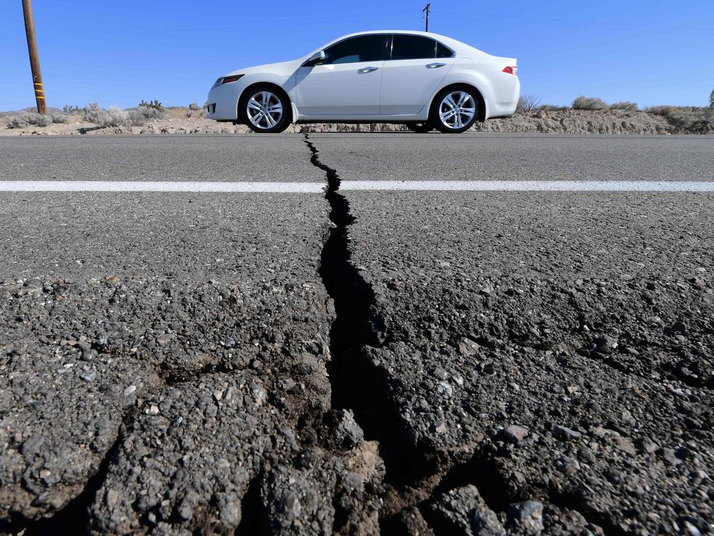 A car drives past a crack in the road after a 6.4-magnitude earthquake in Ridgecrest, California, on July 4, 2019. Picture: Frederic J. Brown/AFP