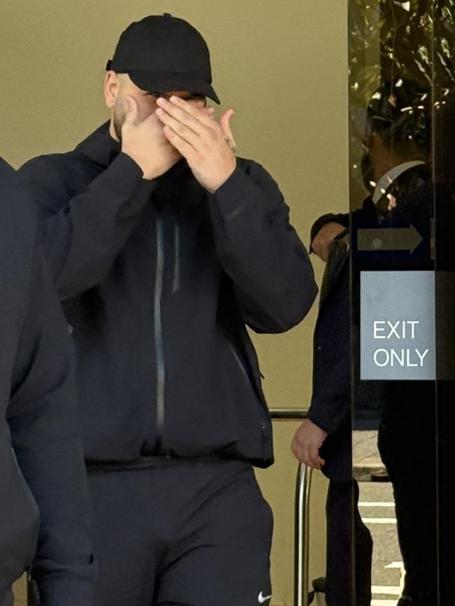 Western Sydney rapper and accused gangster Ali Younes, aka Ay Huncho, hid his face from view as he left Parramatta Local Court flanked by a bodyguard on Thursday.