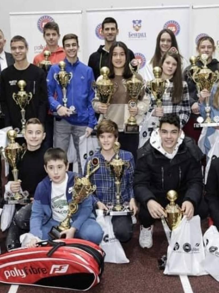 Djokovic (top, middle) attended an award ceremony for children at the Novak Tennis Centre on December 17.