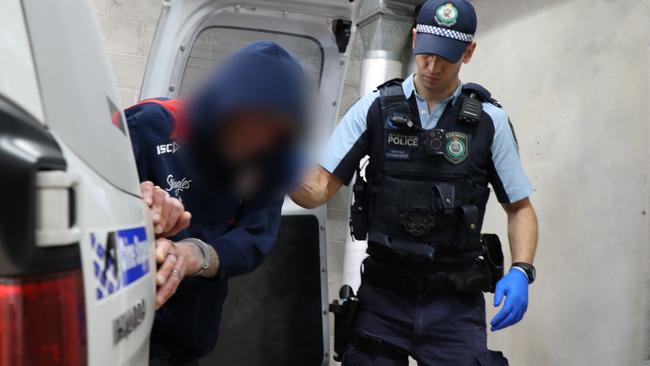 Wallsend man Stephen Barry Bush being led into Waratah police station following his arrest. Picture: NSW Police.