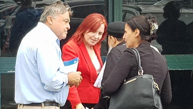 Tony Issa (Liberals) and Julia Finn (ALP) try to woo voters at the Merrylands prepoll on Monday.