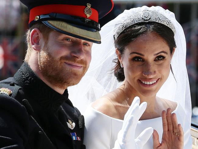 (FILES) In this file photo taken on May 19, 2018 Britain's Prince Harry, Duke of Sussex and his wife Meghan, Duchess of Sussex wave from the Ascot Landau Carriage during their carriage procession on the Long Walk as they head back towards Windsor Castle in Windsor, oafter their wedding ceremony. - Britain's Prince Harry and his wife Meghan will step back as senior members of the royal family and spend more time in North America, the couple said in a historic statement Wednesday. (Photo by Aaron Chown / POOL / AFP)