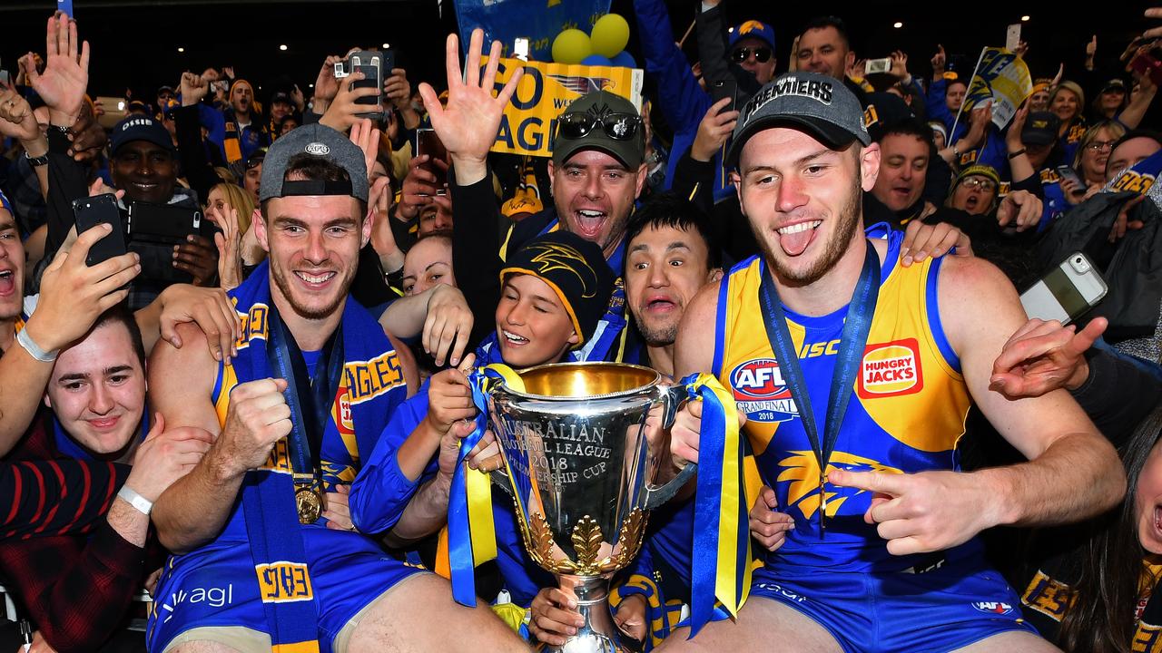 Daniel Venables (right) of the Eagles holds the premiership trophy after winning during the 2018 AFL Grand Final. (AAP Image/Julian Smith)