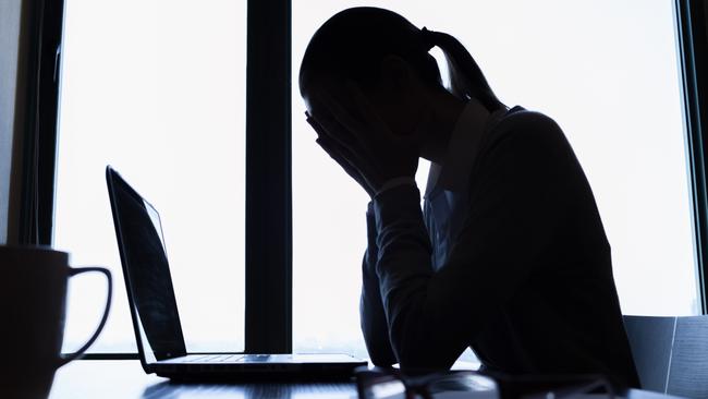 Stressed out businesswoman in office.