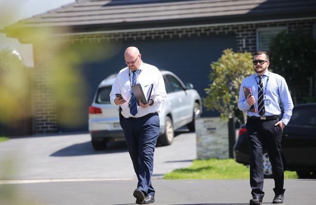 Detectives talk to neighbours in Harrington Park. Picture: John Grainger