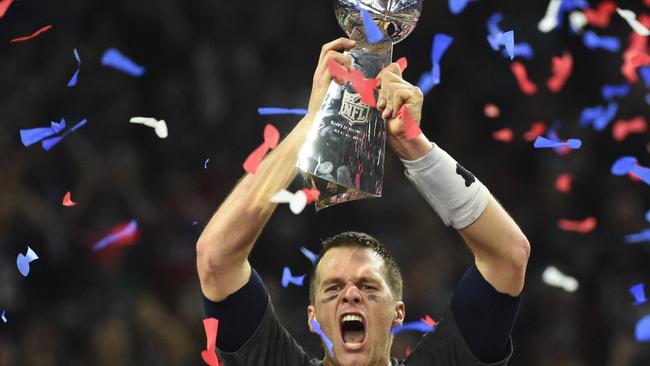 (FILES) In this file photo taken on February 05, 2017, Tom Brady of the New England Patriots holds the Vince Lombardi Trophy after defeating the Atlanta Falcons 34-28 in overtime during Super Bowl 51 in Houston, Texas. - NFL icon Tom Brady confirmed his retirement from the sport on February 1, 2022, officially bringing the curtain down on a glittering 22-season career. The 44-year-old superstar, widely regarded as the greatest quarterback in history, made the announcement in a post on Instagram. (Photo by Timothy A. CLARY / AFP)