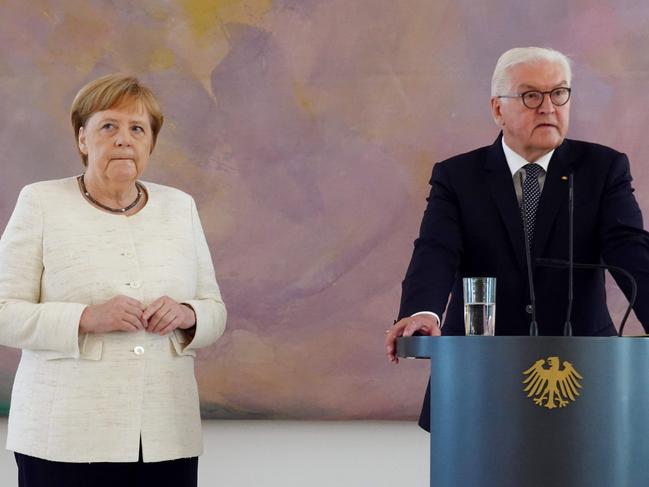 German Chancellor Angela Merkel attends a ceremony alongside German President Frank-Walter Steinmeier. Picture: AFP