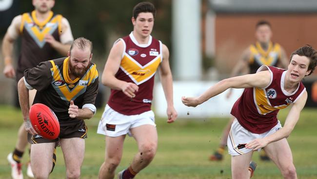 Nicholas Horman (left) charges after the ball for Thomastown. Picture: Hamish Blair.