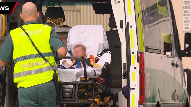 A baby being treated and taken away by paramedics after a crash at Cavan. Picture: 7NEWS Adelaide