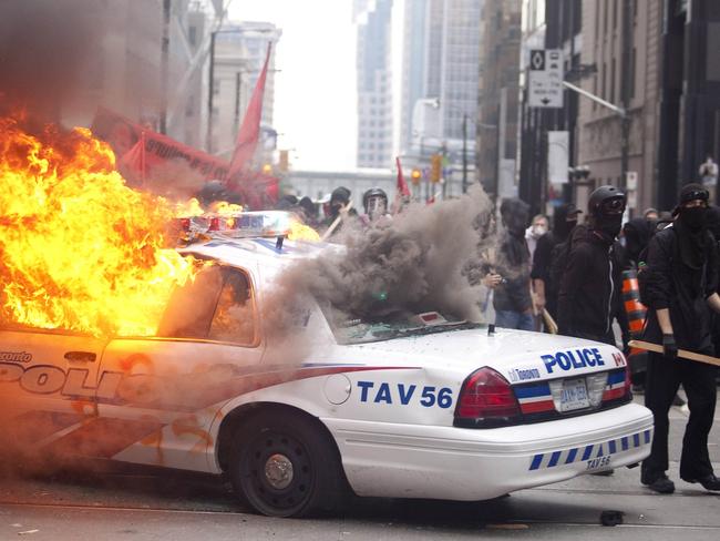 Protesters smash police vehicles in Toronto in 2010. Picture: AFP/Geoff Robins