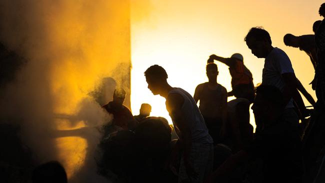 Palestinians search through the rubble of a collapsed building searching for survivors and victims following the Israeli bombardment of Khan Yunis in the southern Gaza Strip. Picture: Mahmud Hams/AFP