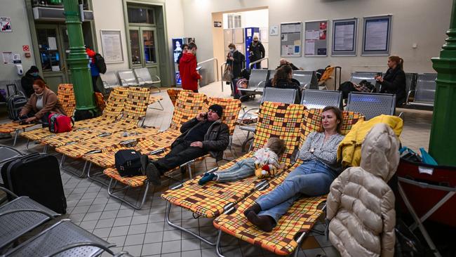 Ukrainian citizens take an overnight rest in a temporary shelter after arriving in Poland on a train from Kyiv. Picture: Omar Marques/Getty Images